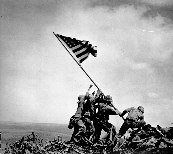 soilders help to put up American flag at Iwo Jima Japan in black and white