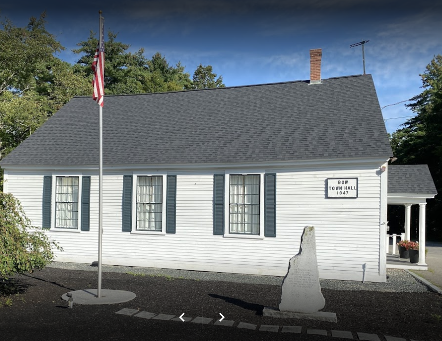 Old Town Hall 1847, white building with dark roof and black shutter with flag pole and flag and monument of NH and home of the Marine Corps League Dillion Detachment monthly meetings.