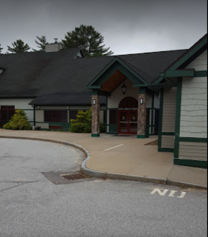 Front of a community center in Meredith, NH with arch entry and sidewalk with double doors. Home of the Marine Corps League Lakes Region Detachment